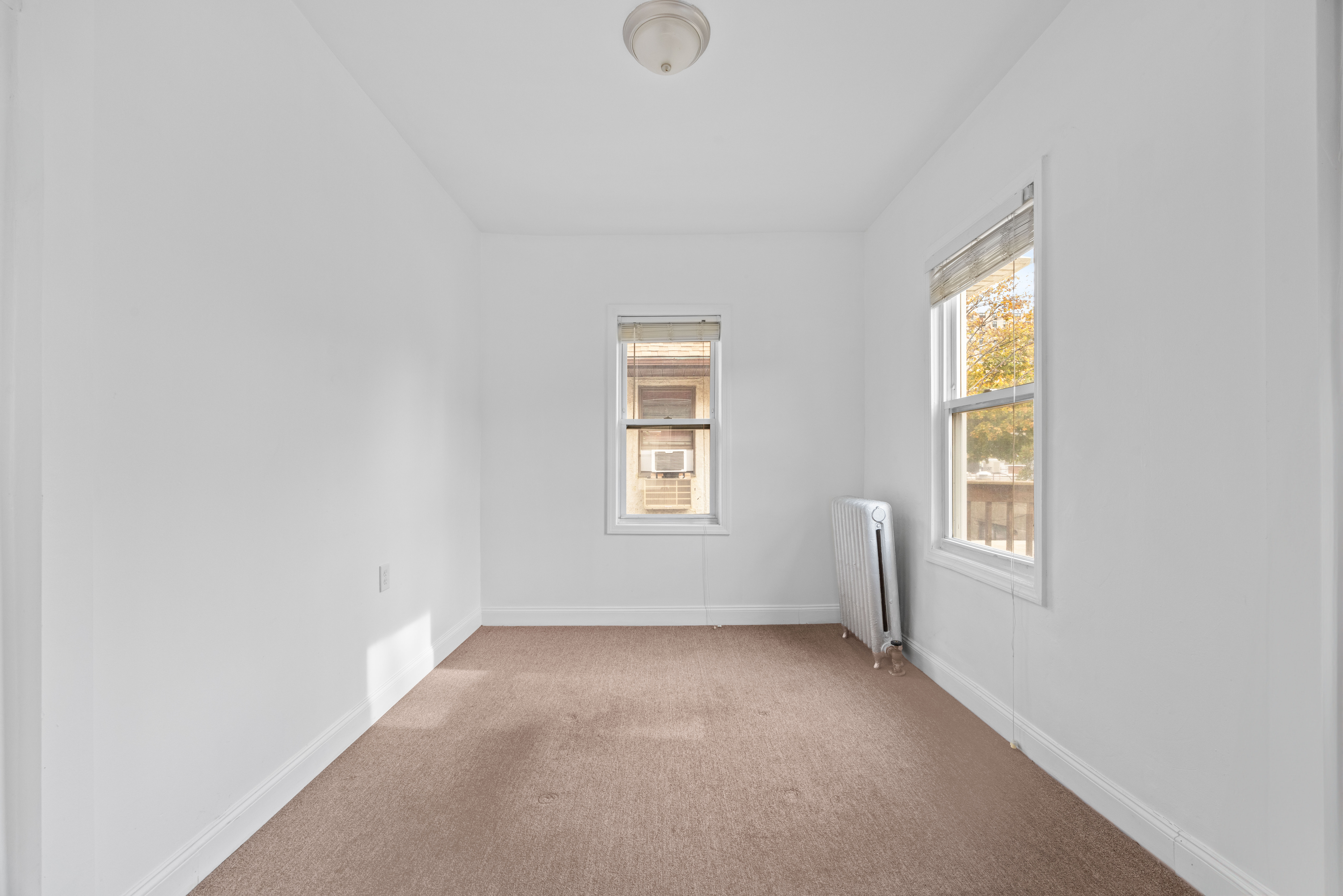 3712 Oceanic Avenue, Unit 2 Brooklyn, NY 11224 - Photo 3 of 14 an empty room with windows