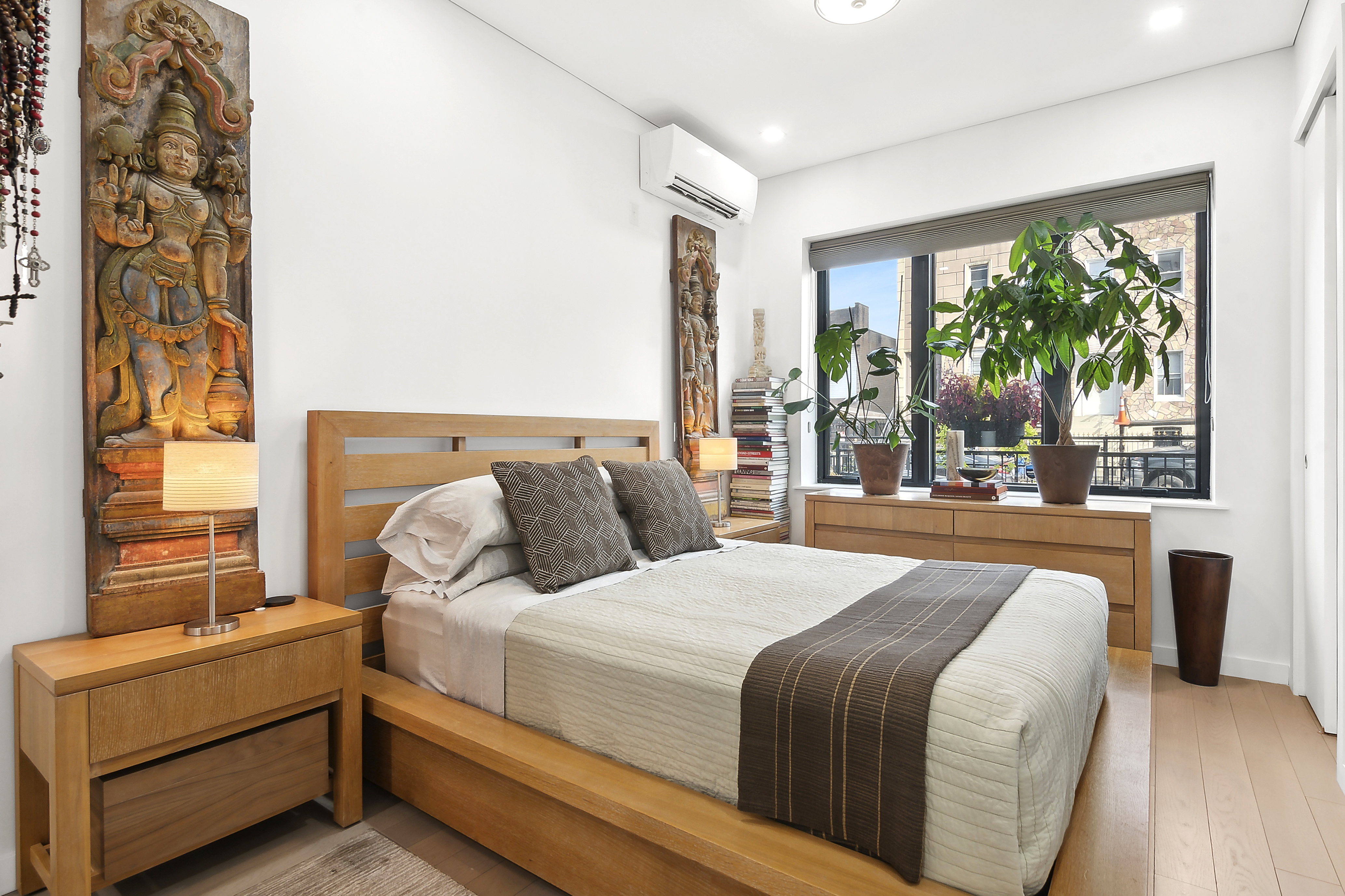 1043 Halsey Street, Unit 1 Brooklyn, NY 11207 - Photo 8 of 14 a bedroom with a large bed and a large window with outer view