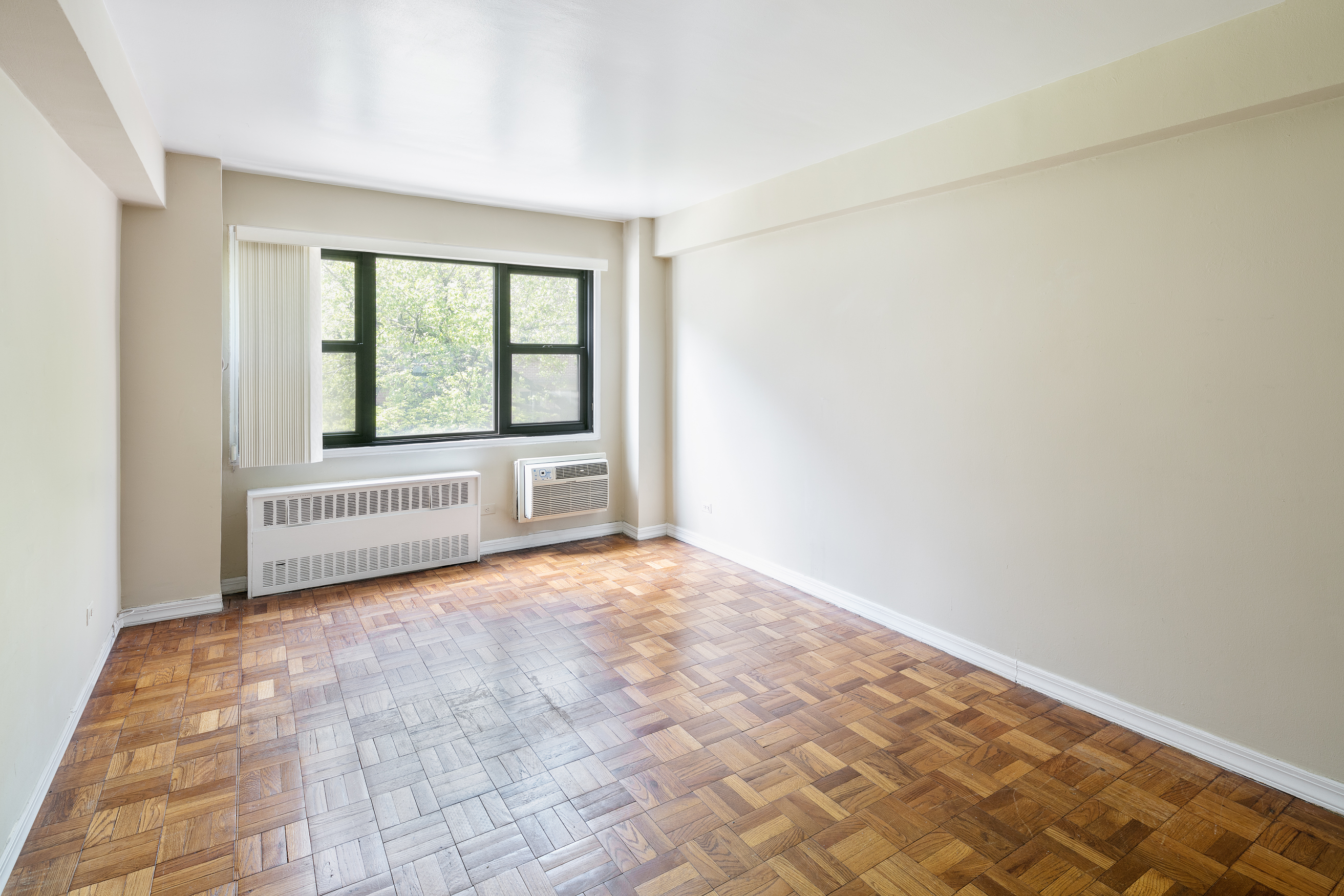 335 East 51st Street, Unit 2D Manhattan, NY 10022 - Photo 6 of 11 a view of an empty room with a window