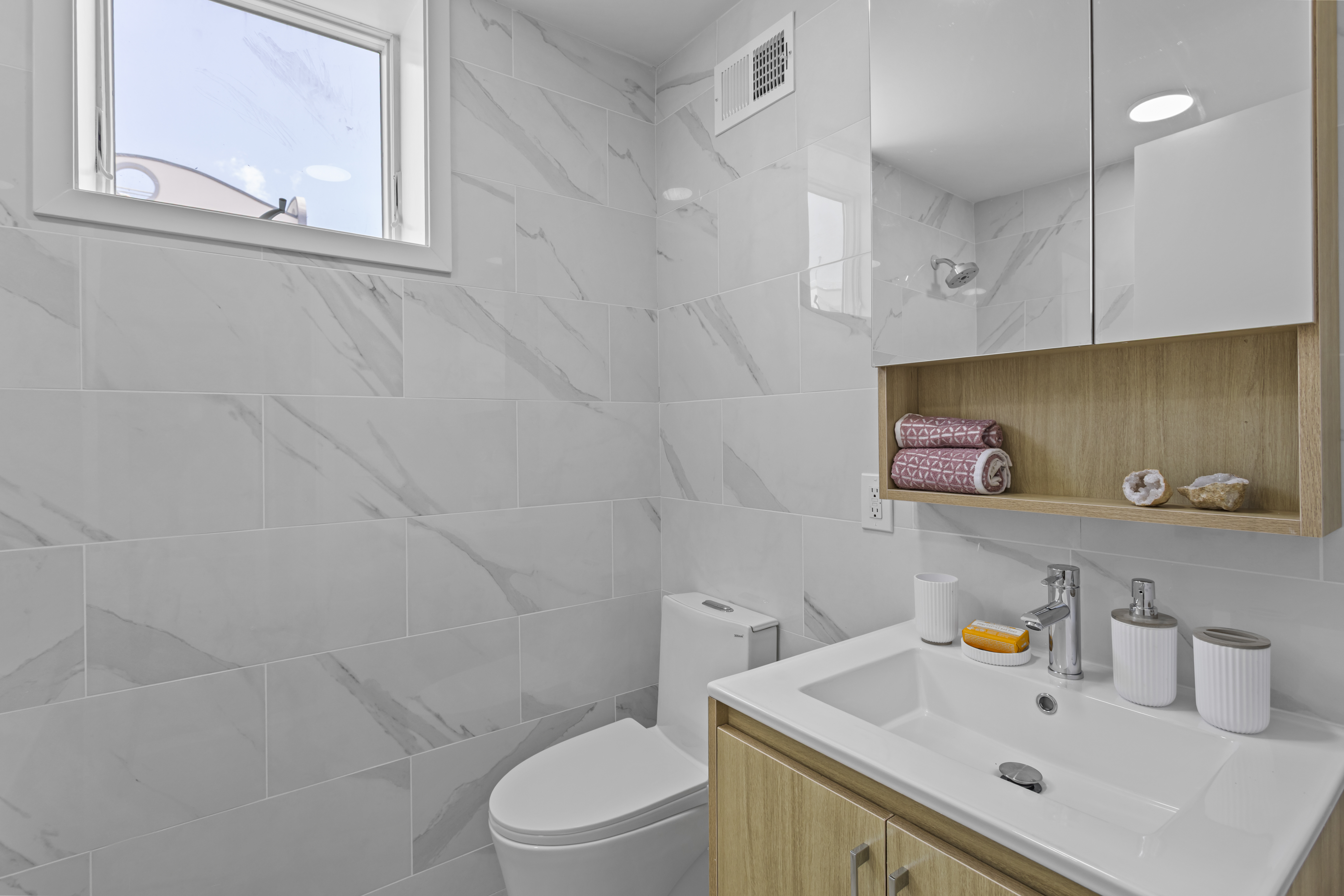 3112 Emmons Avenue, Unit 3124A2 Brooklyn, NY 11235 - Photo 6 of 17 a bathroom with a sink a toilet and vanity