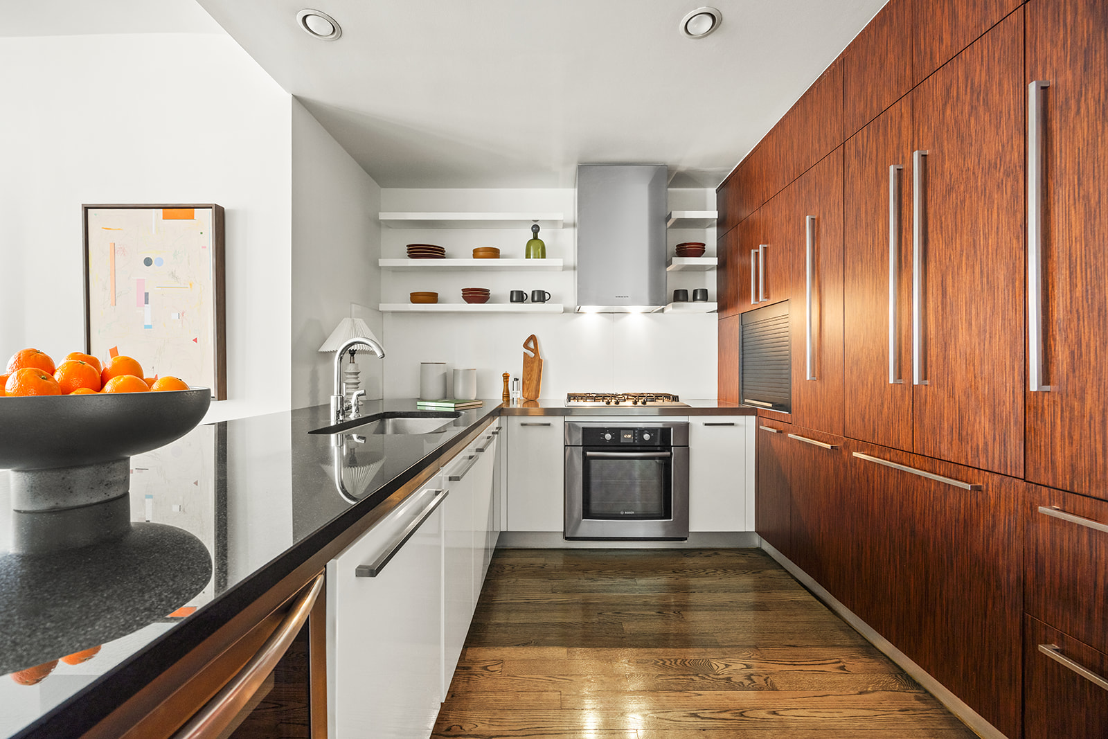 133 West 22nd Street, Unit 8G Manhattan, NY 10011 - Photo 3 of 16 a kitchen with stainless steel appliances a sink and a refrigerator