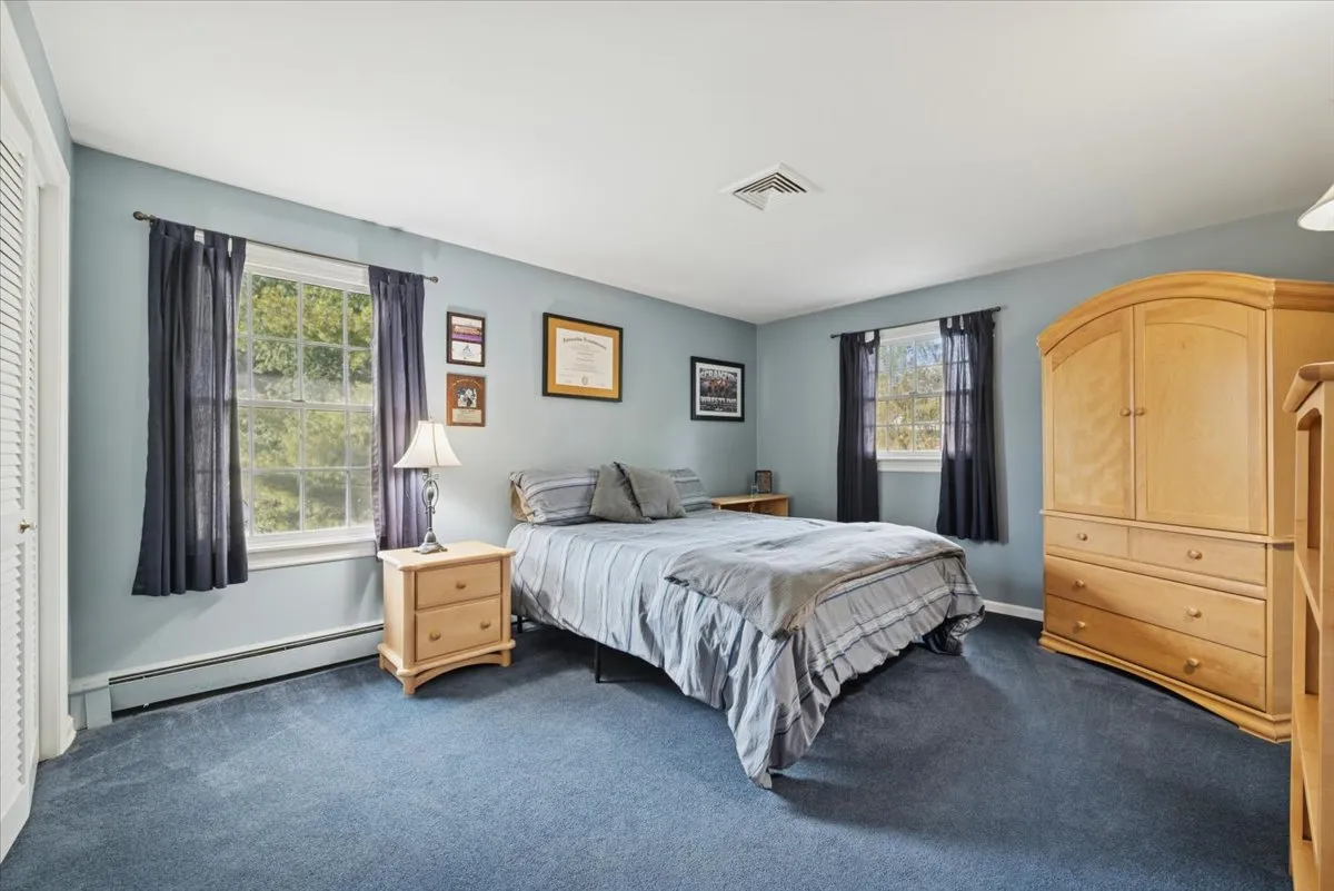 a bathroom with a granite countertop sink toilet a mirror and shower