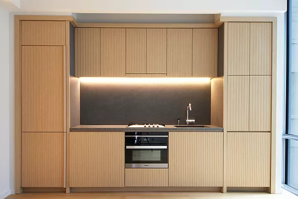 565 Broome Street, Unit N6J Manhattan, NY 10013 - Photo 2 of 27 a kitchen with a refrigerator and white cabinets