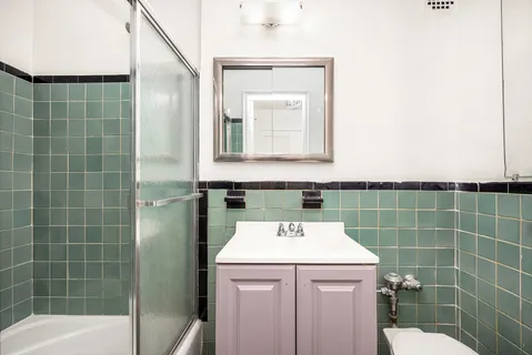 a bathroom with a sink a toilet and a mirror