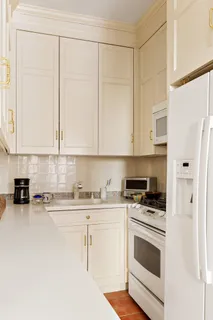 a kitchen with stainless steel appliances white cabinets and a stove