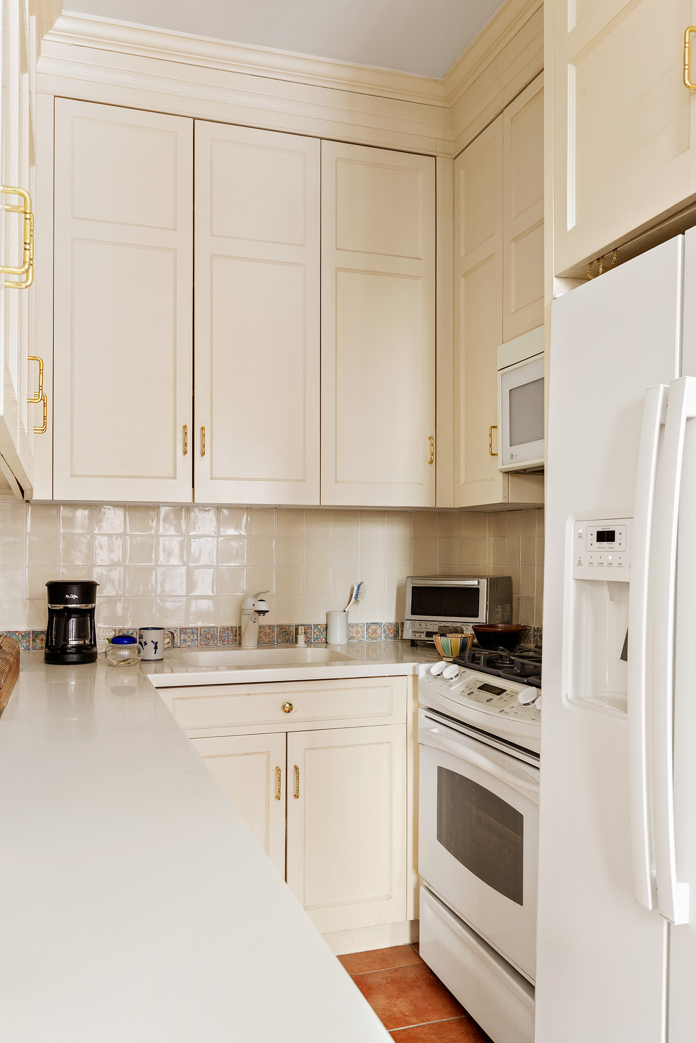 139 East 94th Street, Unit 7D Manhattan, NY 10128 - Photo 5 of 11 a kitchen with stainless steel appliances white cabinets and a stove