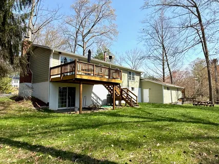a view of a house with yard and a tree