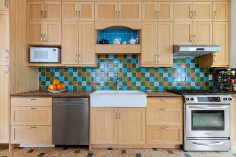 a kitchen with stainless steel appliances granite countertop a stove and cabinets