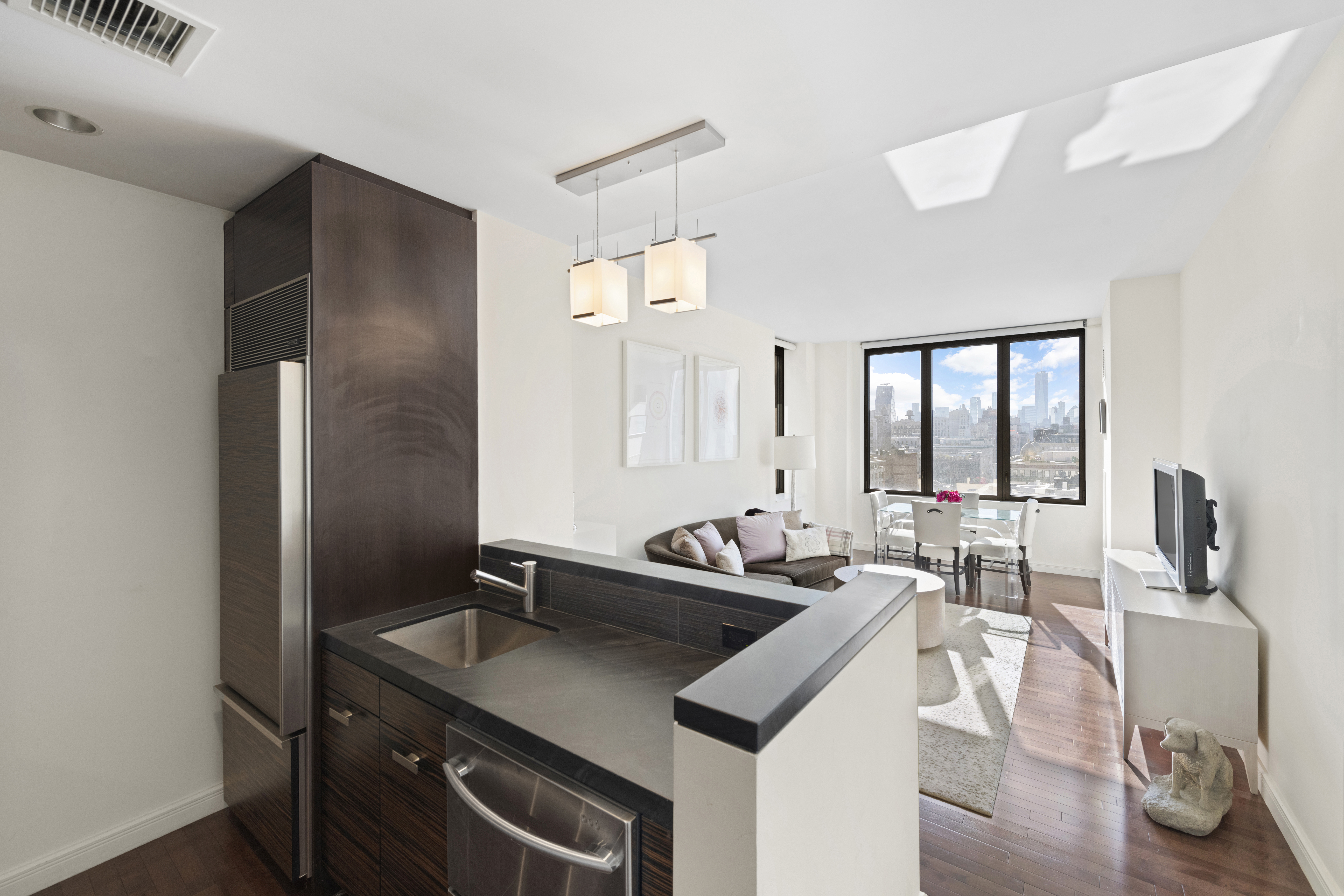 101 West 24th Street, Unit 12C Manhattan, NY 10011 - Photo 3 of 17 a kitchen with a sink stove and cabinets