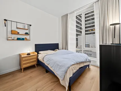 a bedroom with a bed and a window
