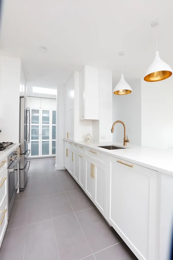 a large white kitchen with a window
