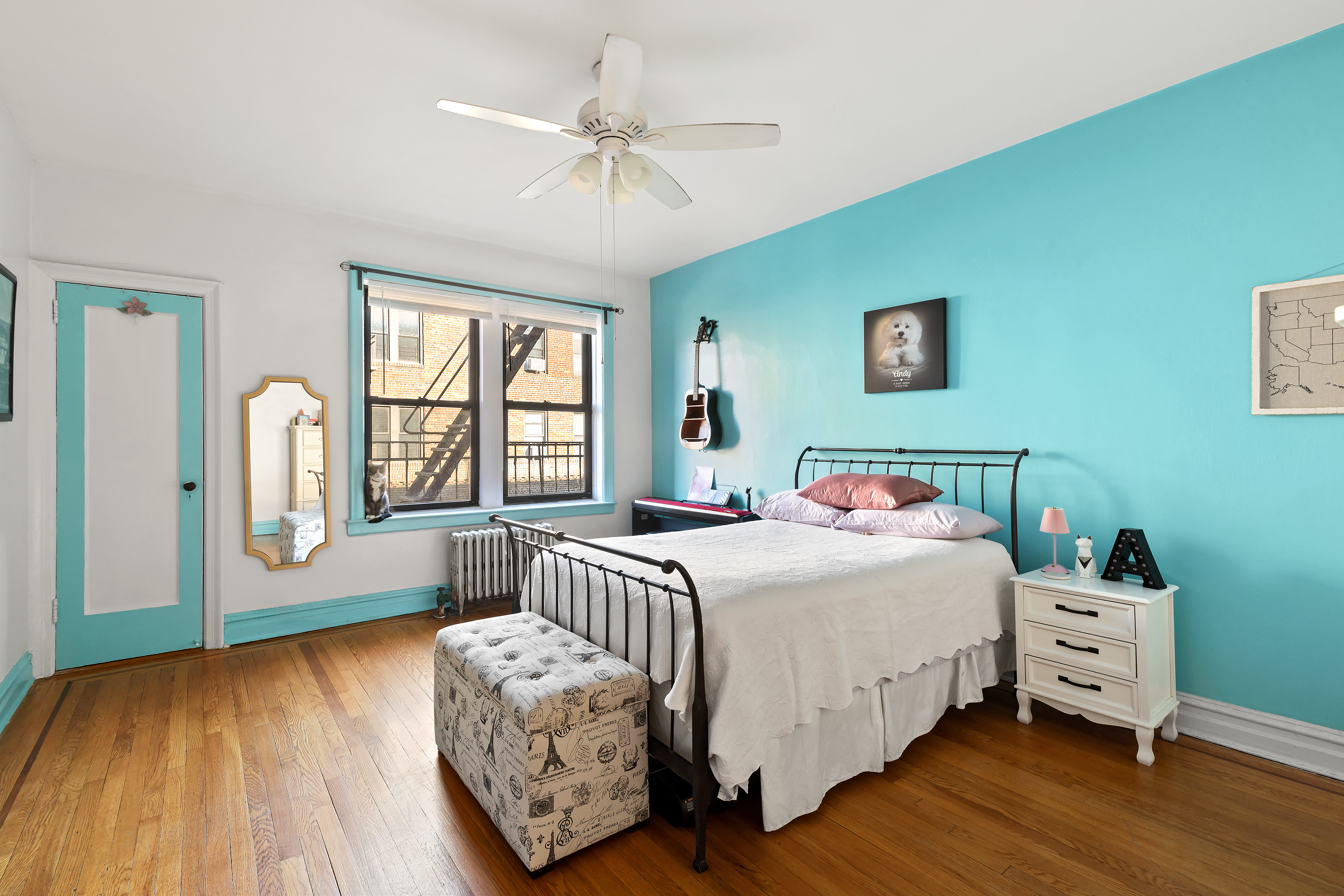 83-10 35th Avenue, Unit 5O Queens, NY 11372 - Photo 5 of 8 a bedroom with a bed and a large window