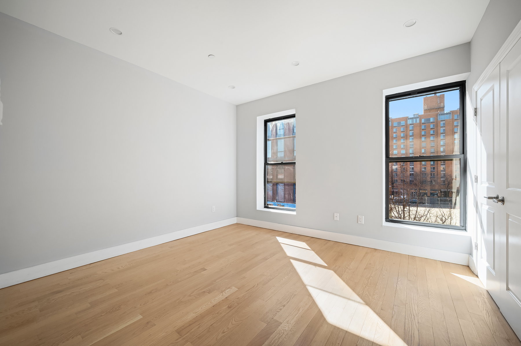307 West 136th Street Manhattan, NY 10030 - Photo 16 of 26 an empty room with windows