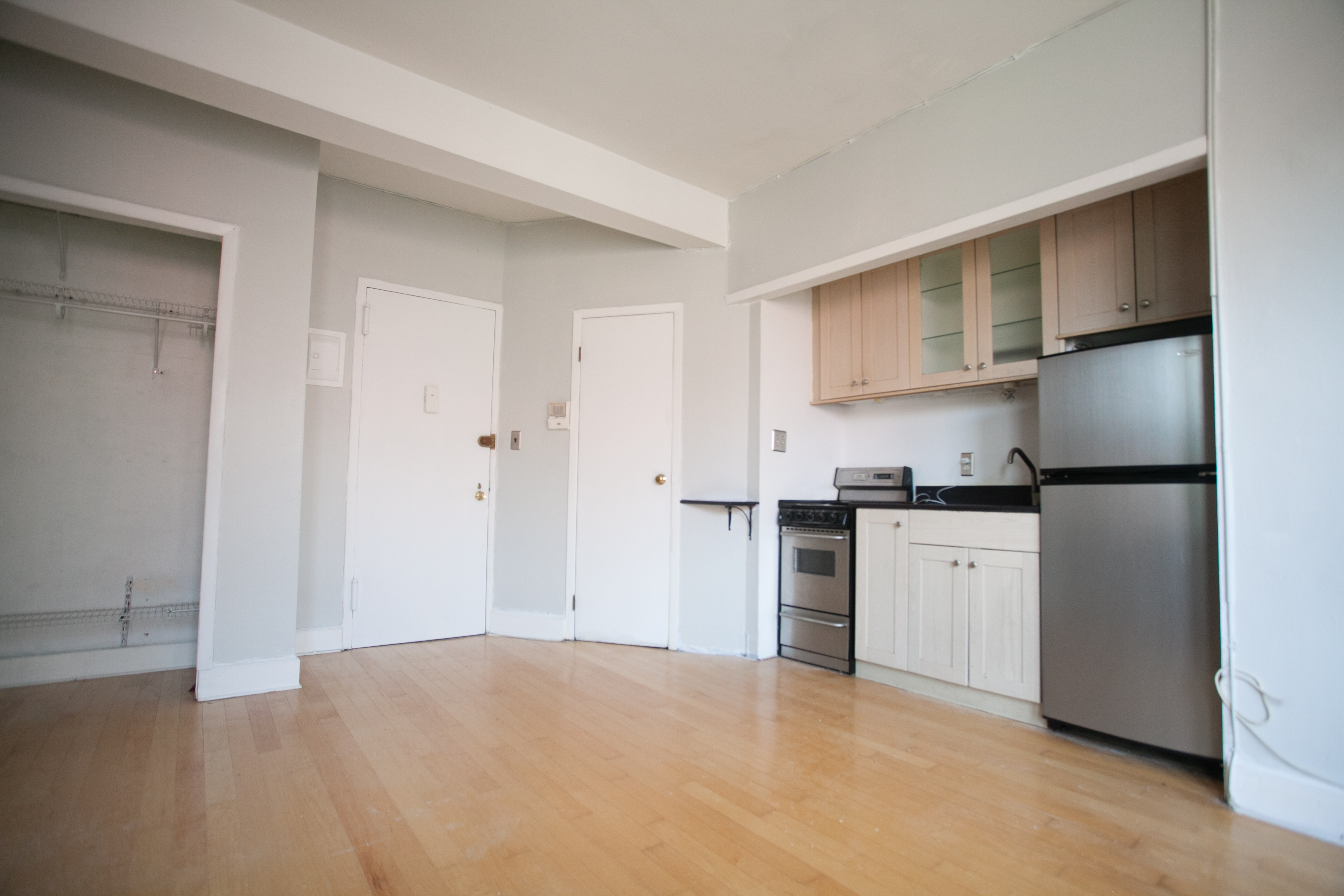 1 Station Square, Unit 404 Queens, NY 11375 - Photo 2 of 8 a kitchen with granite countertop a refrigerator stove top oven and sink