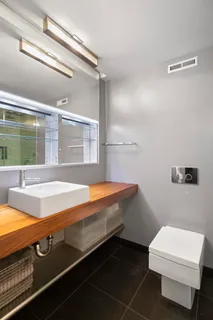 a room with a table chairs and a projector screen