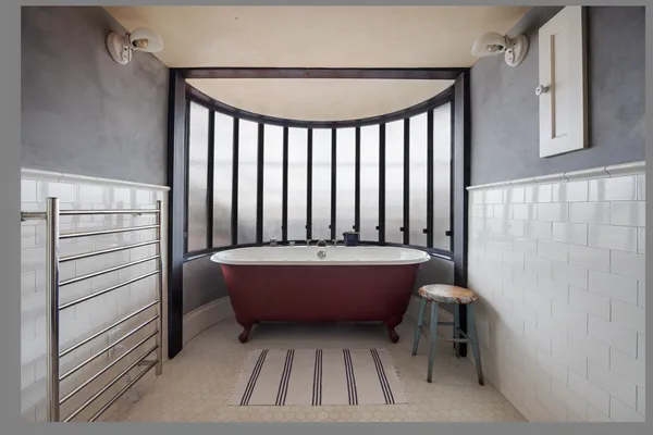 a bathroom with a bathtub and shower