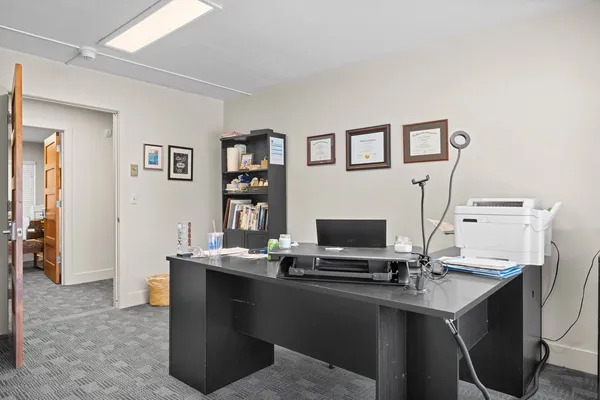 a view of a workspace with furniture