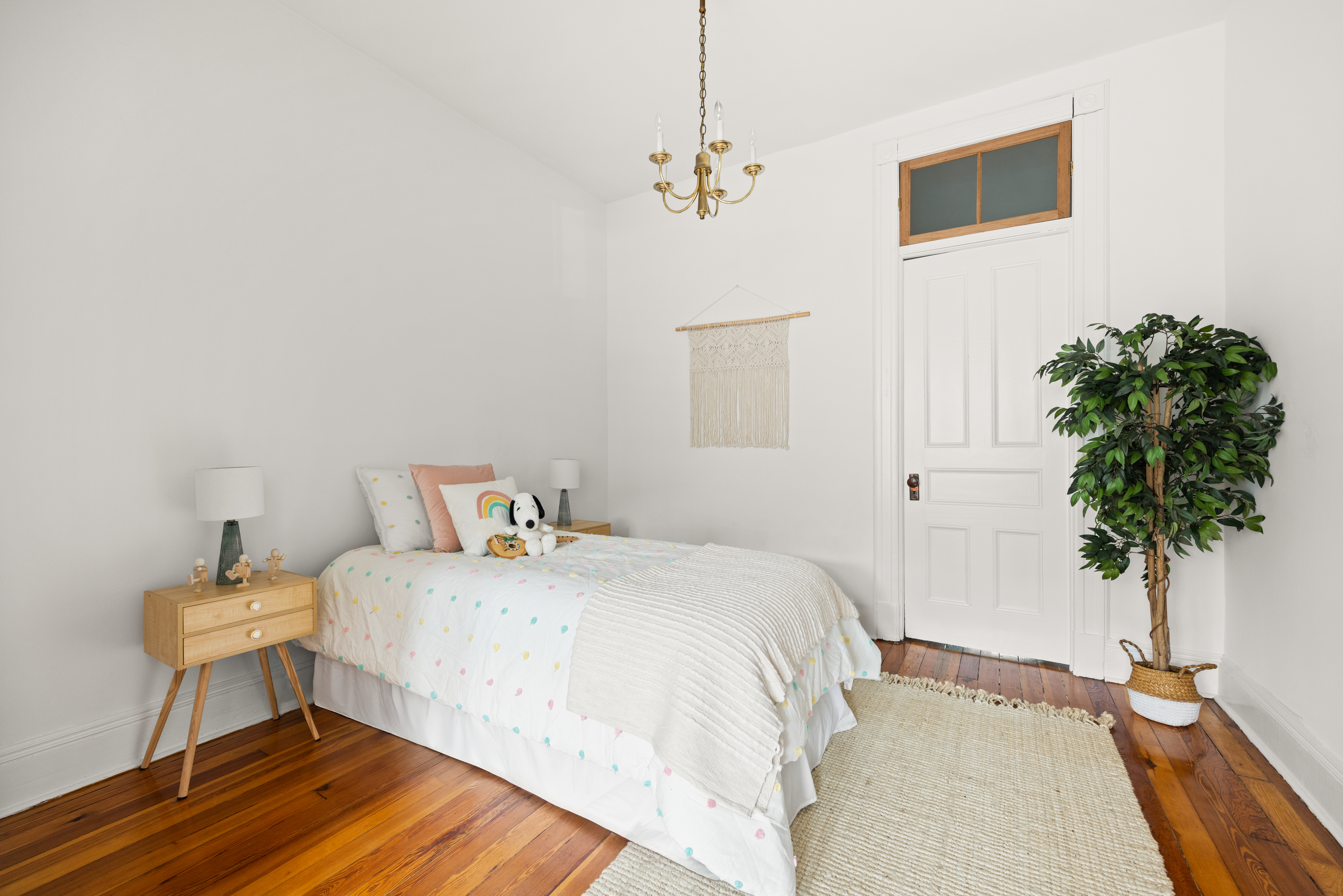 99 East 2nd Street Brooklyn, NY 11218 - Photo 14 of 24 a bedroom with a bed and a potted plant