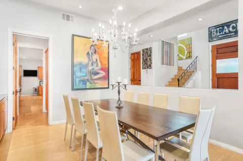 a view of a dining room with furniture and chandelier