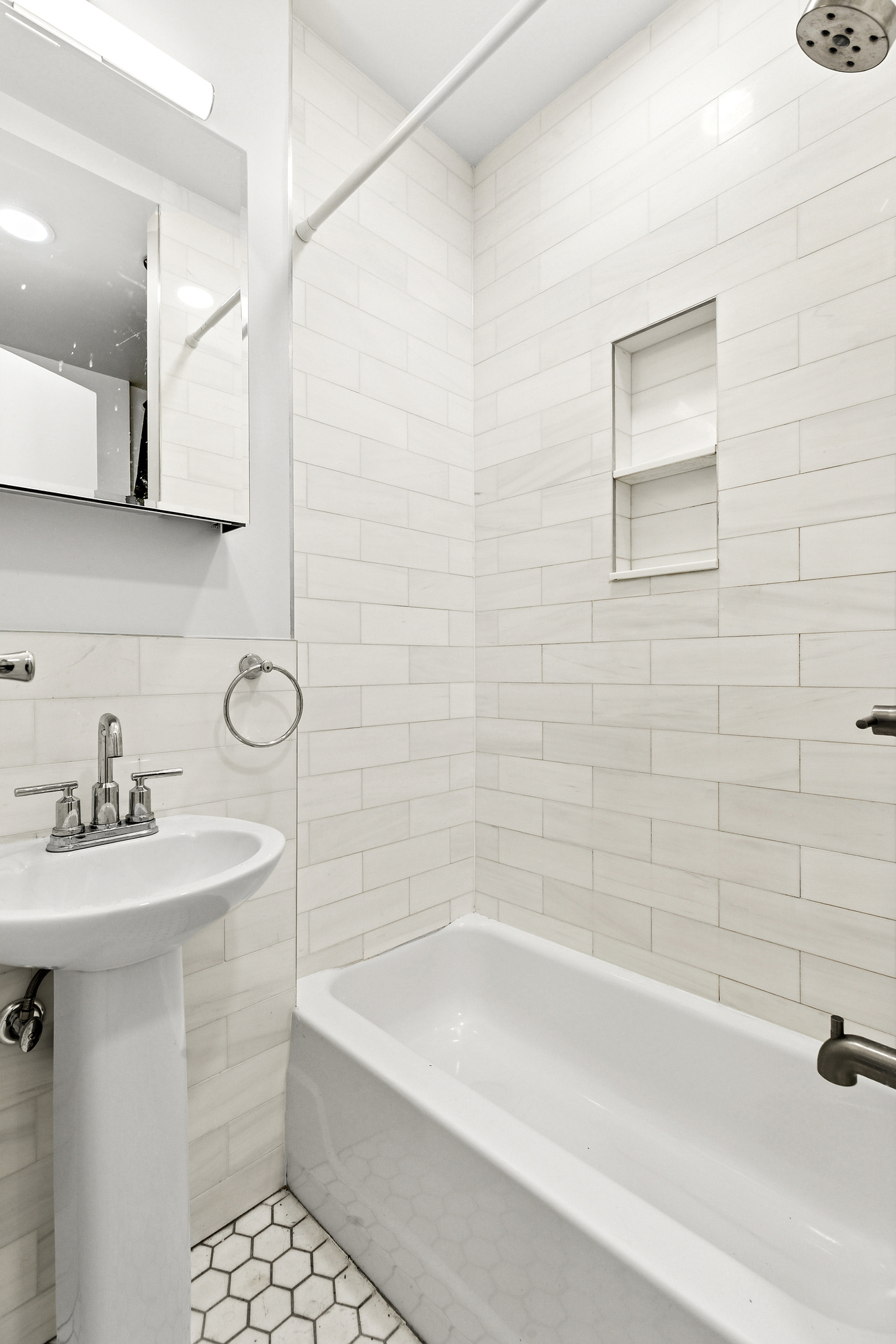 75 Pineapple Street, Unit 2A Brooklyn, NY 11201 - Photo 5 of 6 a bathroom with a sink a bathtub and a shower