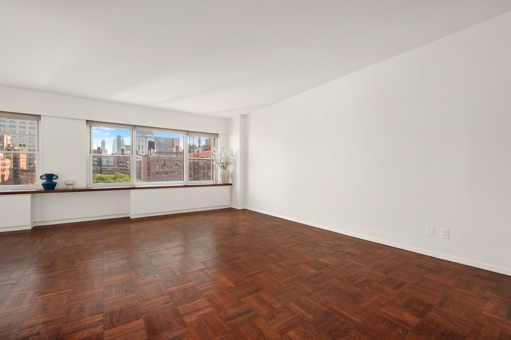 20 East 9th Street, Unit 12X Manhattan, NY 10003 - Photo 2 of 26 an empty room with wooden floor and windows