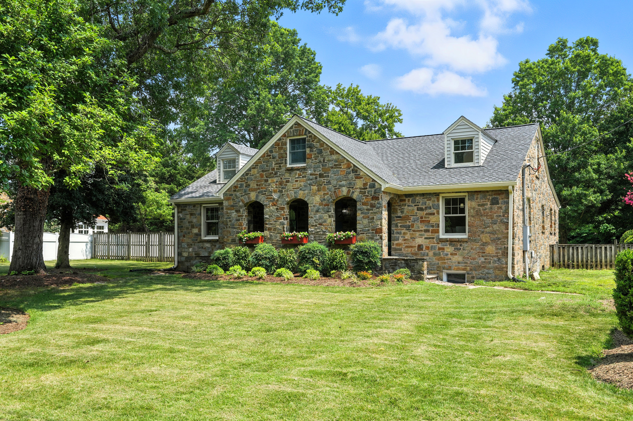 a front view of house with yard and green space