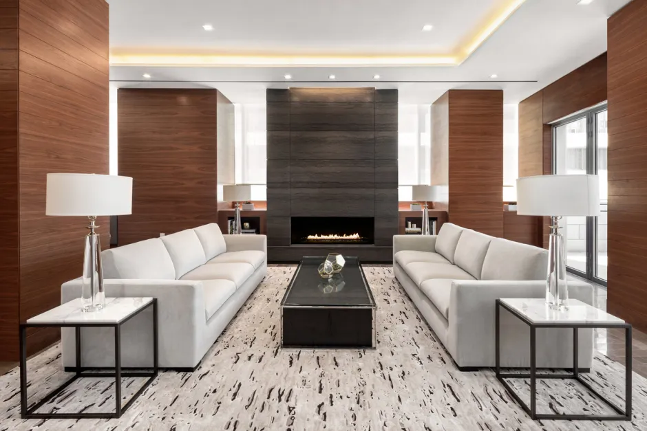 a living room with fireplace furniture and a large window