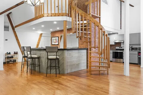 a view of a living room with furniture and wooden floor