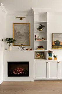 a living room with a fireplace and a flat screen tv