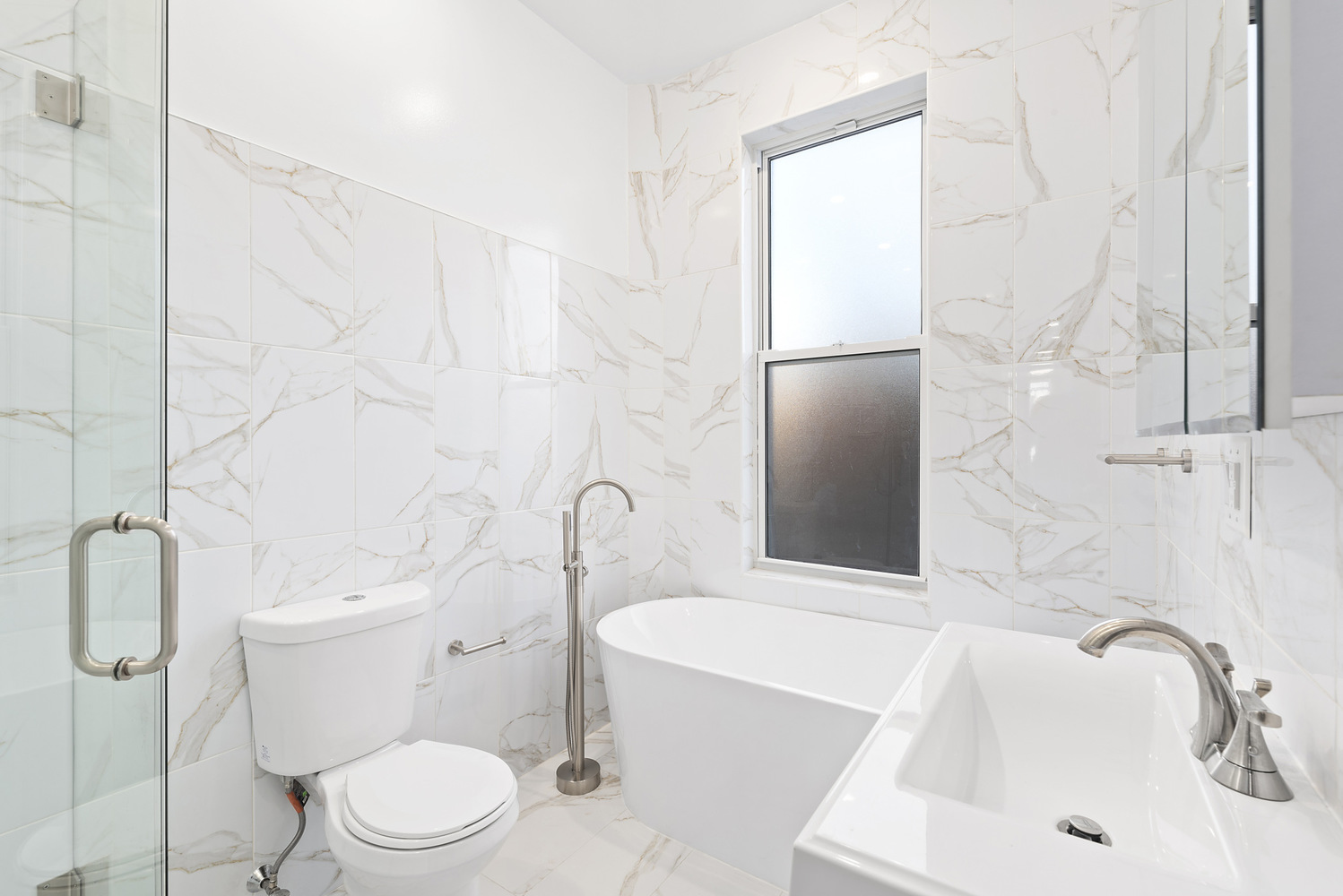 1275 Jefferson Avenue, Unit 3 Brooklyn, NY 11221 - Photo 6 of 6 a white toilet sitting next to a bath tub