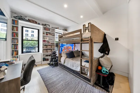 a bedroom with furniture and a window