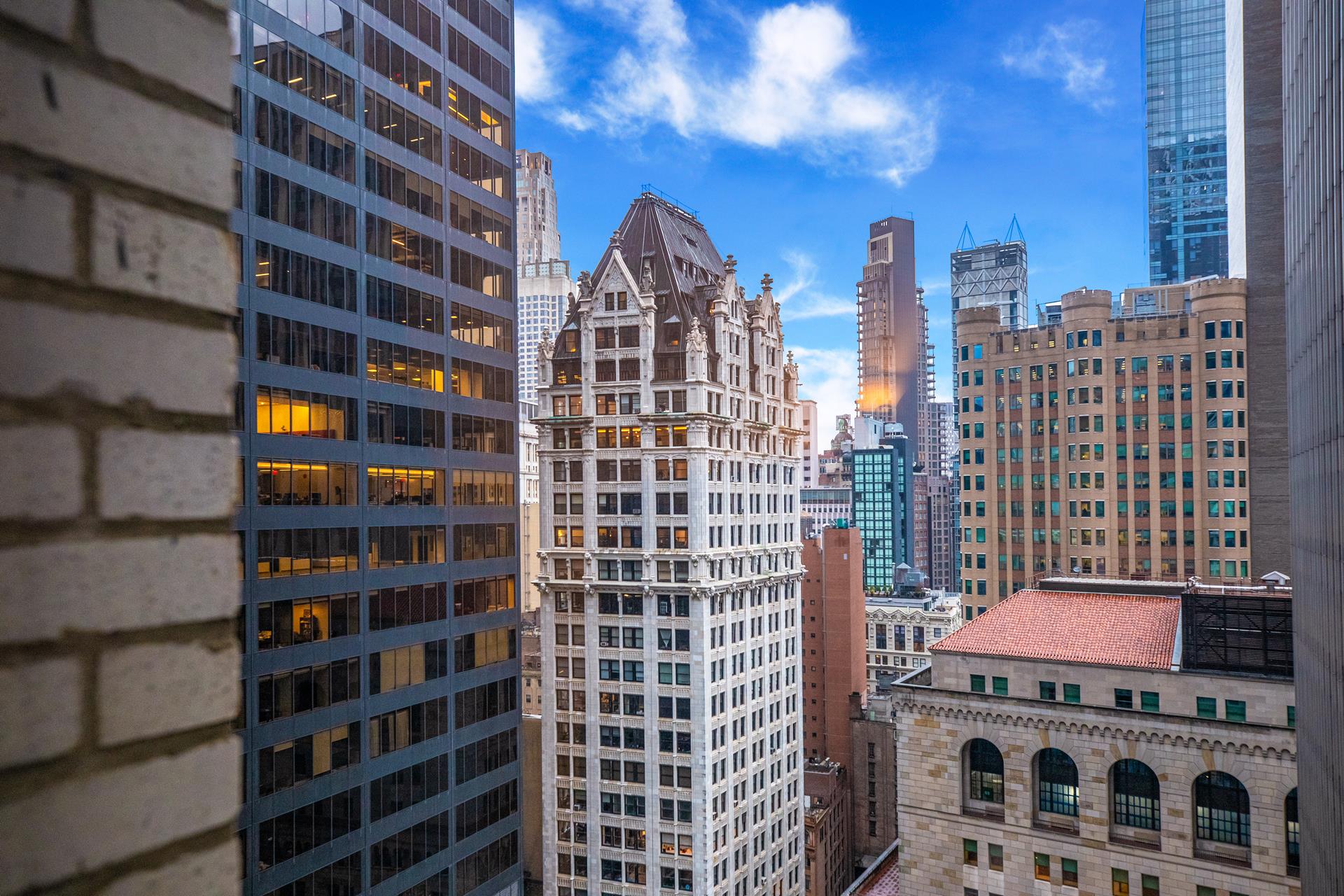 20 Pine Street, Unit 2410 Manhattan, NY 10005 - Photo 5 of 6 a view of a city with tall buildings