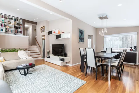a living room with furniture a dining table and a wooden floor