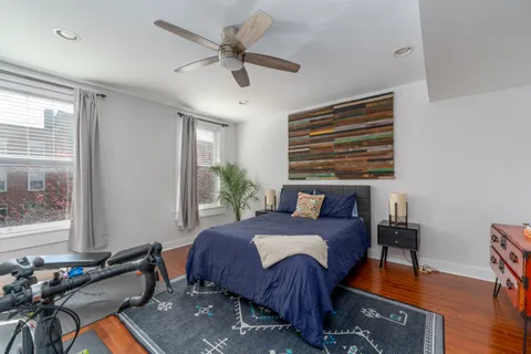a bedroom with a bed dresser and a window
