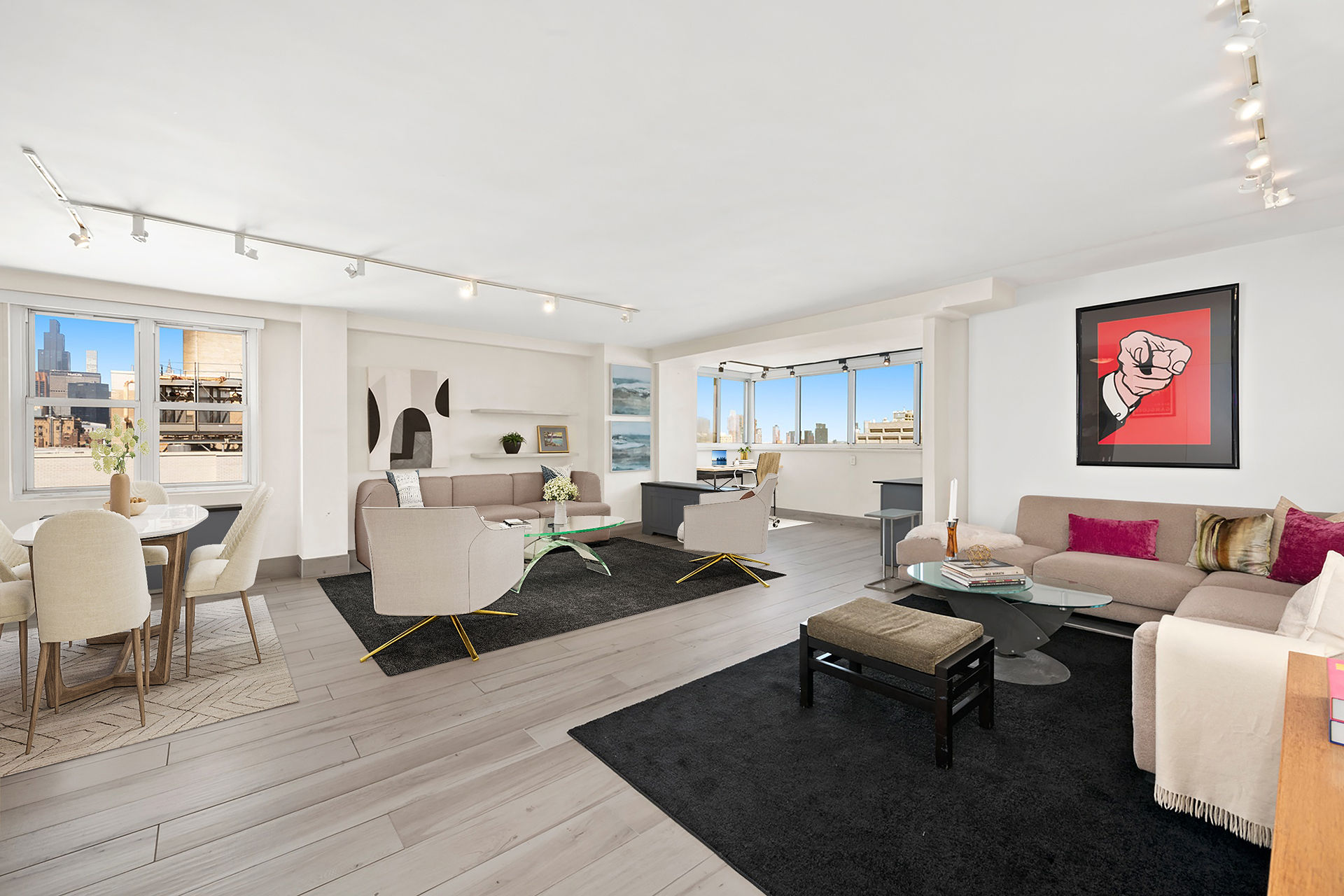 a living room with couches a coffee table and kitchen view with wooden floor