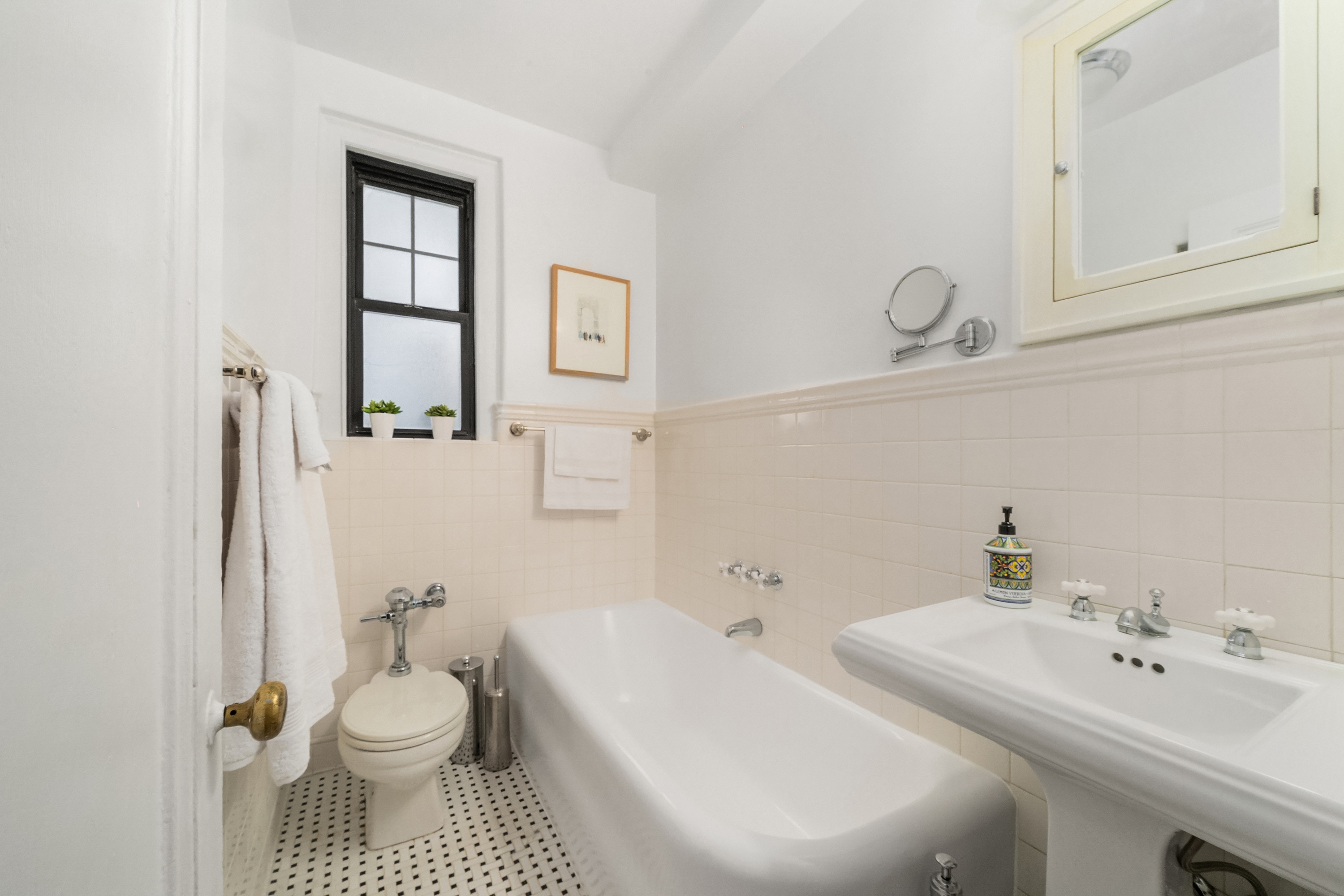 170 2nd Avenue, Unit 2D Manhattan, NY 10003 - Photo 7 of 11 a bathroom with a toilet sink and mirror