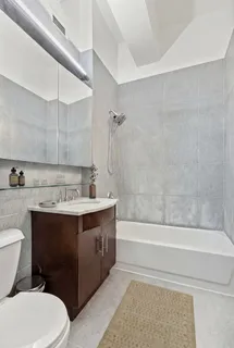 a bathroom with a sink a toilet and bathtub