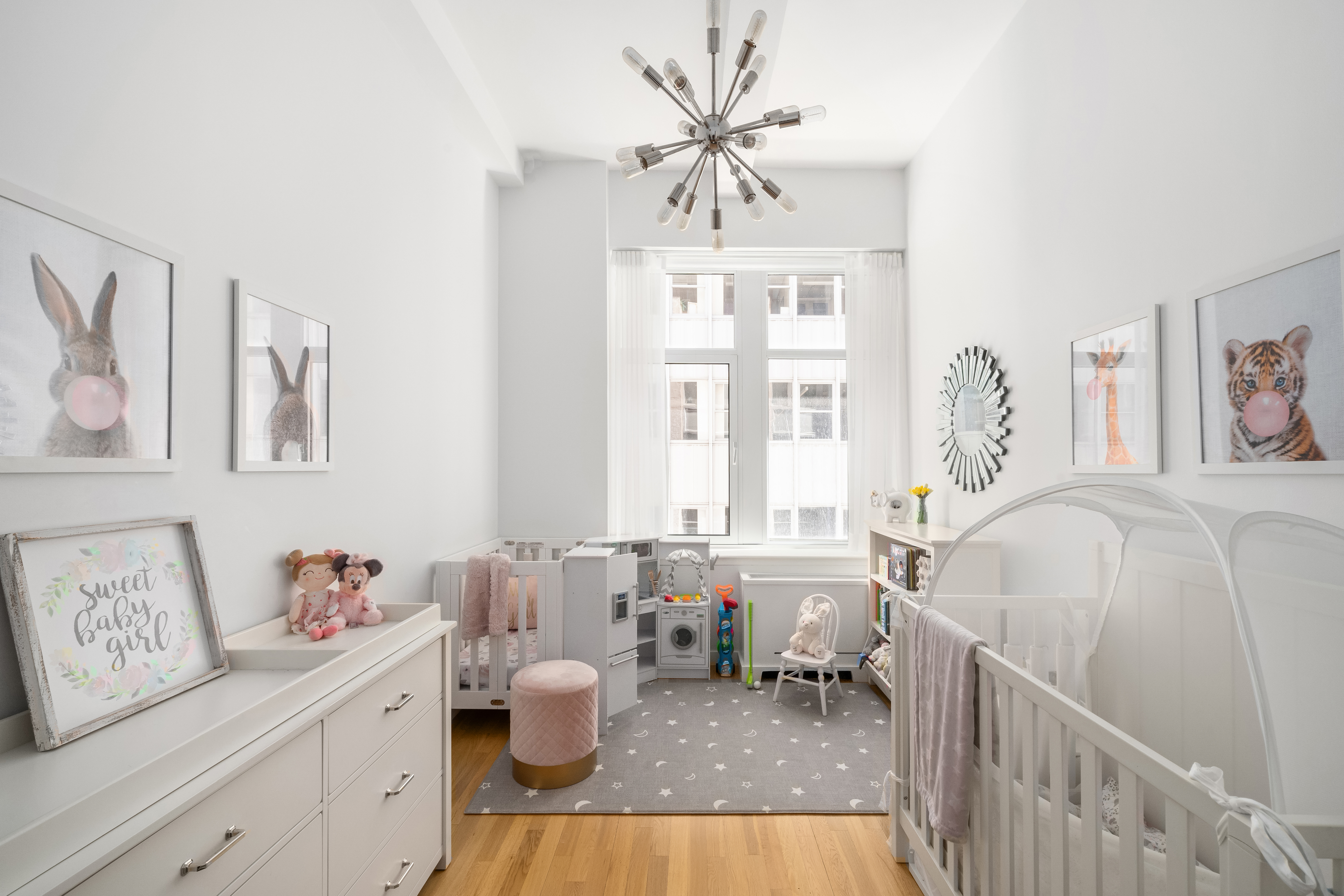 59 John Street, Unit 7D Manhattan, NY 10038 - Photo 7 of 10 a living room with furniture and a chandelier