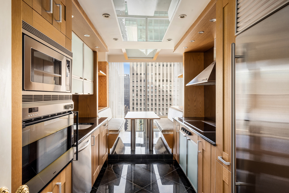 641 5th Avenue, Unit 27A Manhattan, NY 10022 - Photo 7 of 29 a view of a hallway with wooden floor and staircase