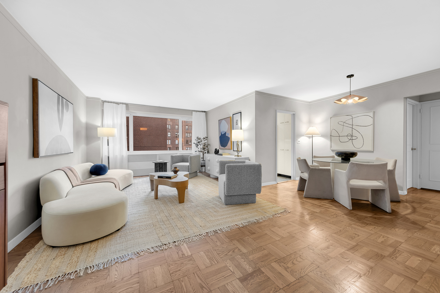 411 East 53rd Street, Unit 8C Manhattan, NY 10022 - Photo 1 of 10 a living room with furniture and a large window