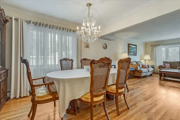 a view of a dining room with furniture and chandelier