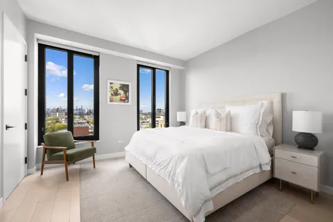 a bedroom with a bed and a large window