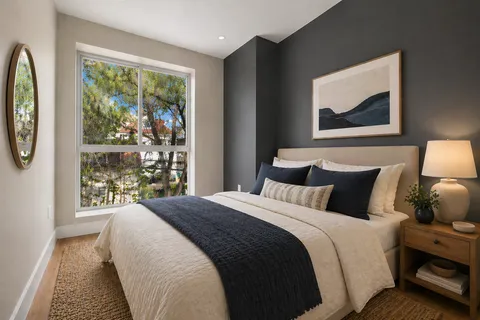 a bedroom with a large bed and a window