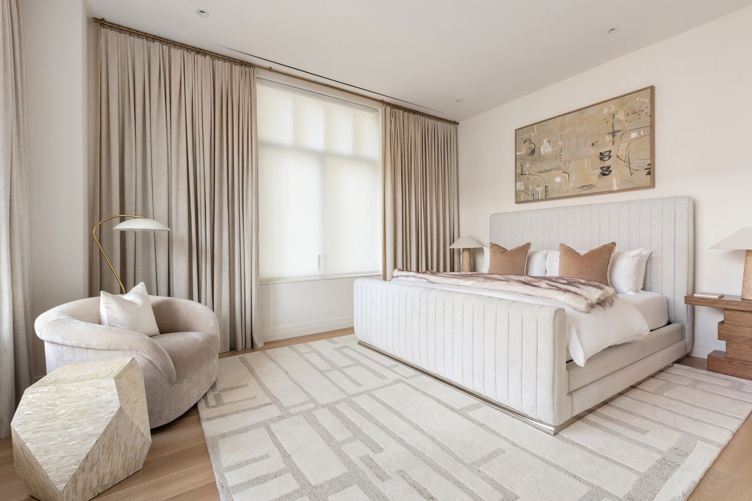 a bedroom with a bed and a large window