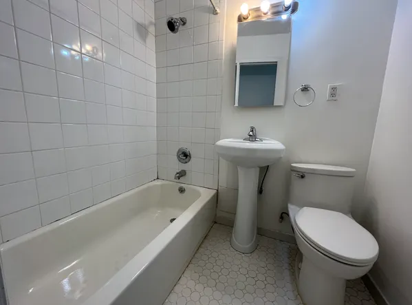 a bathroom with a sink a toilet and bathtub