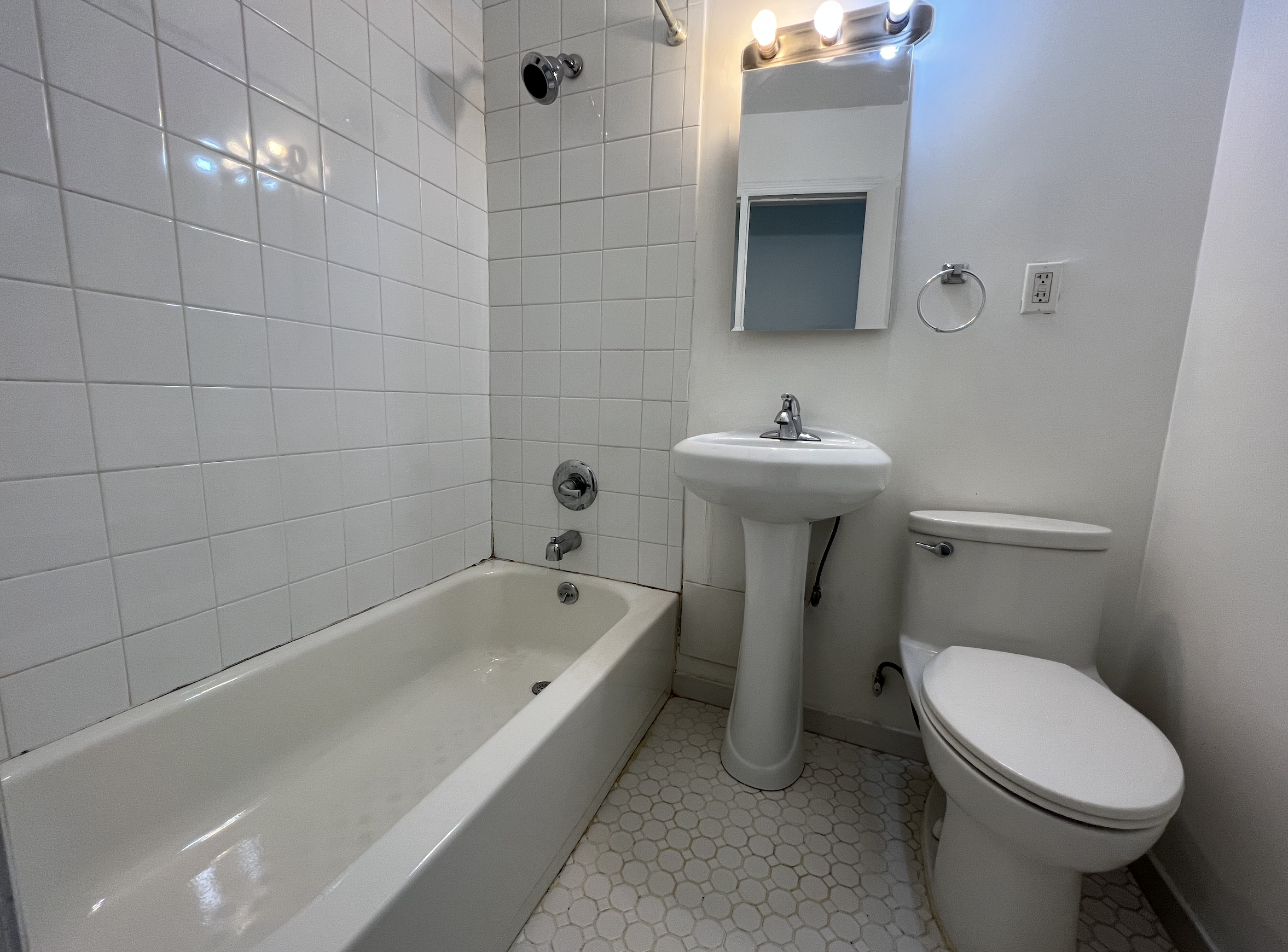 446 West 46th Street, Unit 5 Manhattan, NY 10036 - Photo 7 of 15 a bathroom with a sink a toilet and bathtub