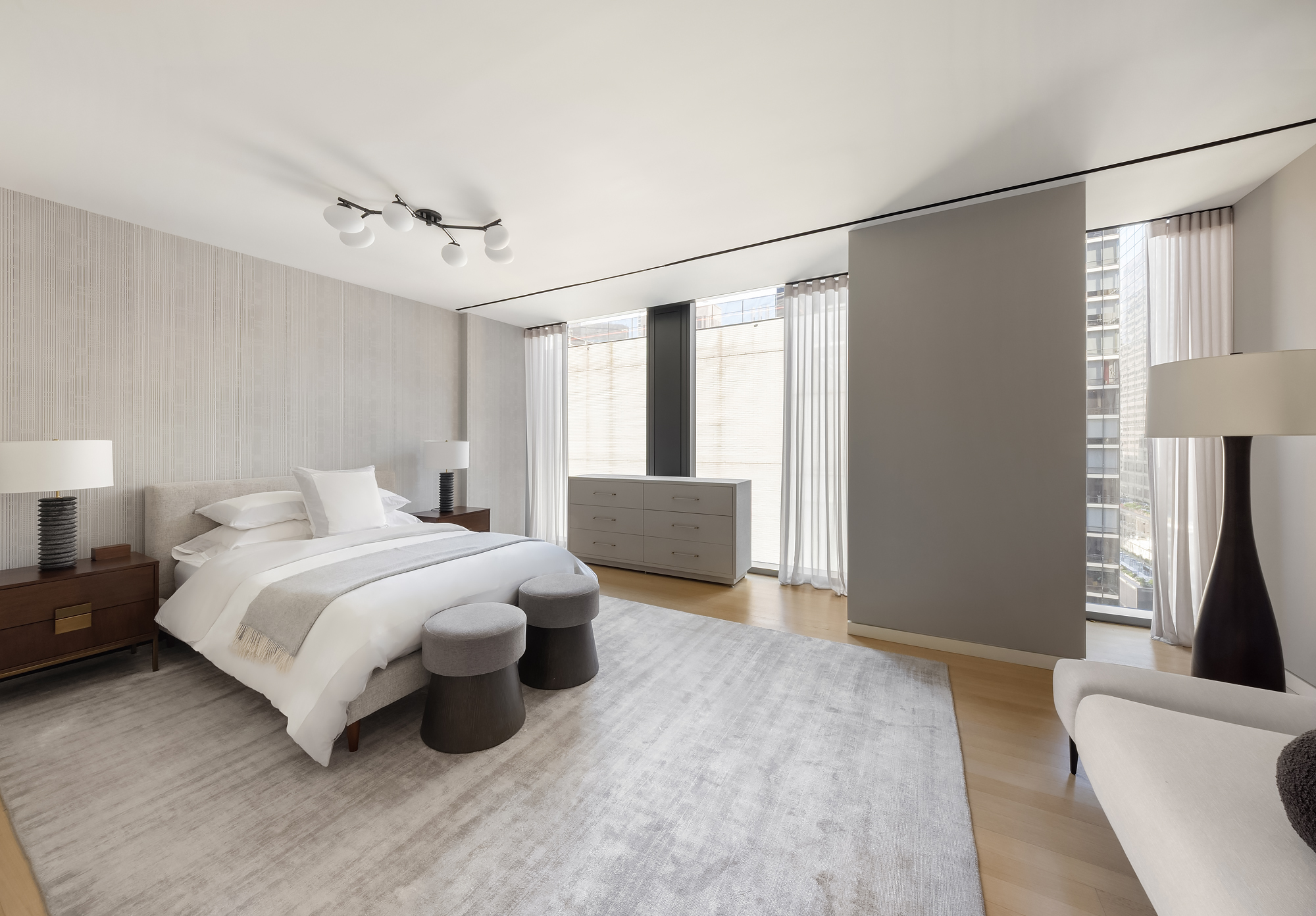 53 West 53rd Street, Unit 23D Manhattan, NY 10019 - Photo 7 of 11 a bedroom with a bed and a couch