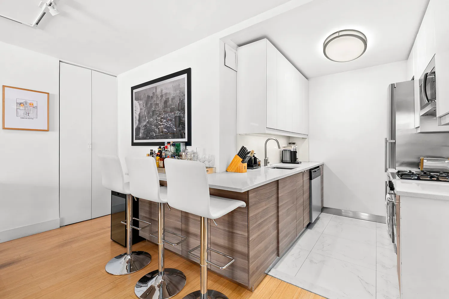a kitchen with a sink cabinets and wooden floor