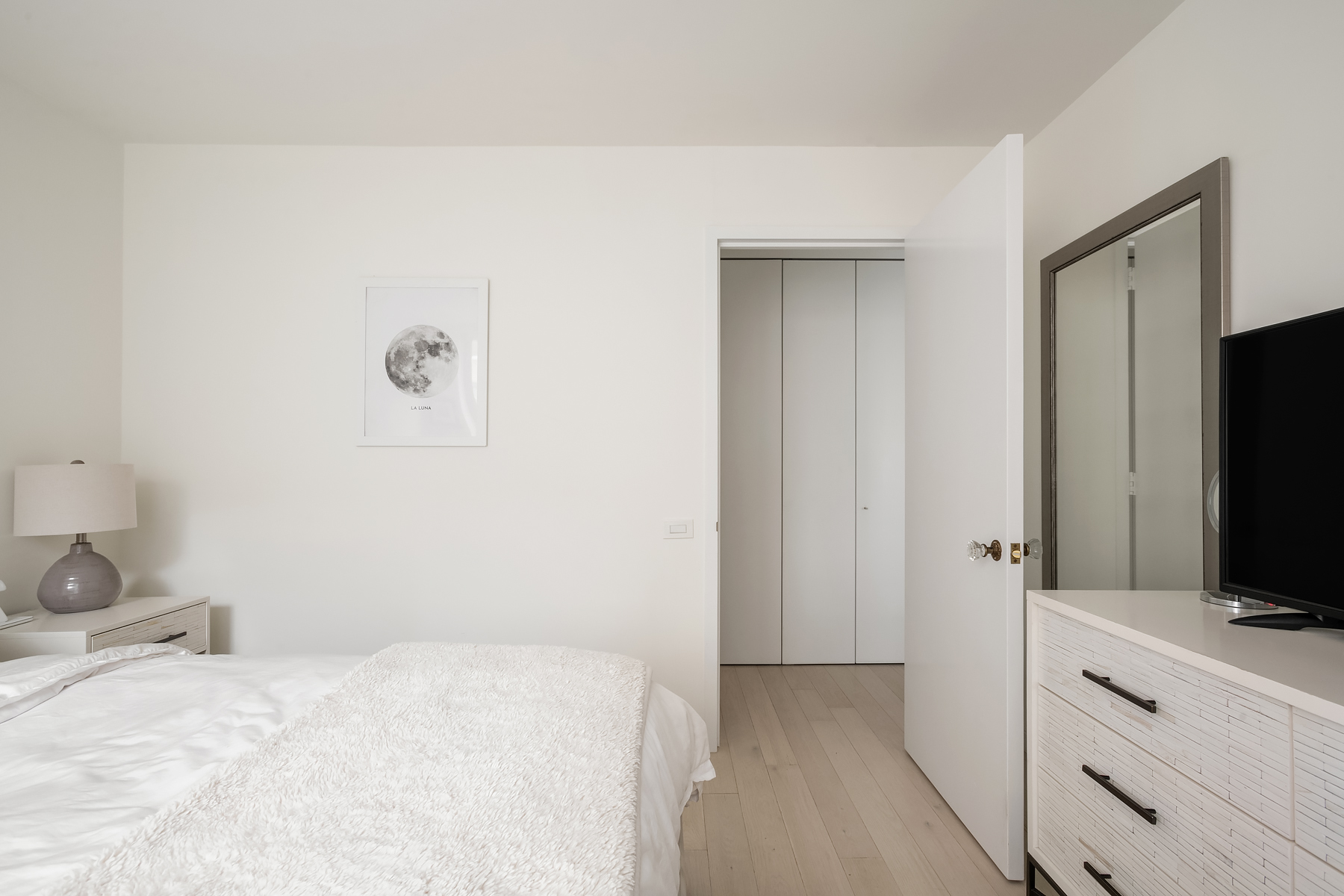 330 East 75th Street, Unit 3L Manhattan, NY 10021 - Photo 7 of 14 a bedroom with a bed and a flat tv screen in it