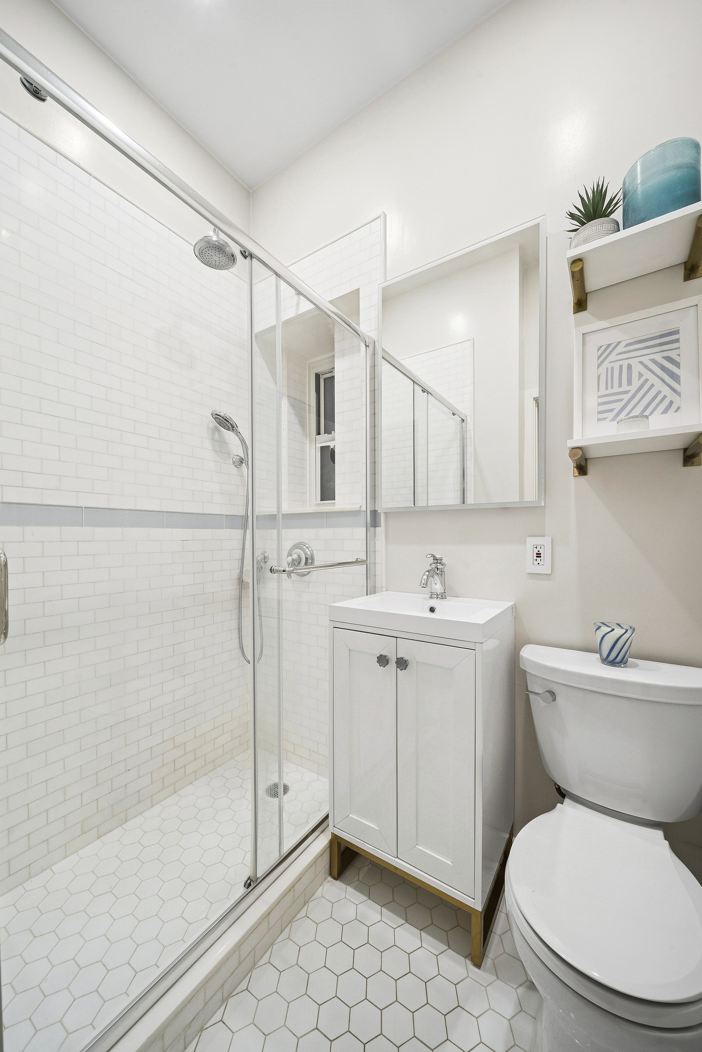252 West 20th Street, Unit 2B Manhattan, NY 10011 - Photo 5 of 6 a bathroom with a sink toilet and shower